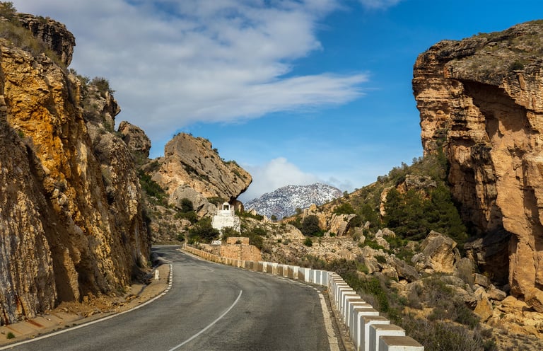 The gorge known as "Cortao de las Peñas" with the snow-capped Sierra de la Pila mountain range in th