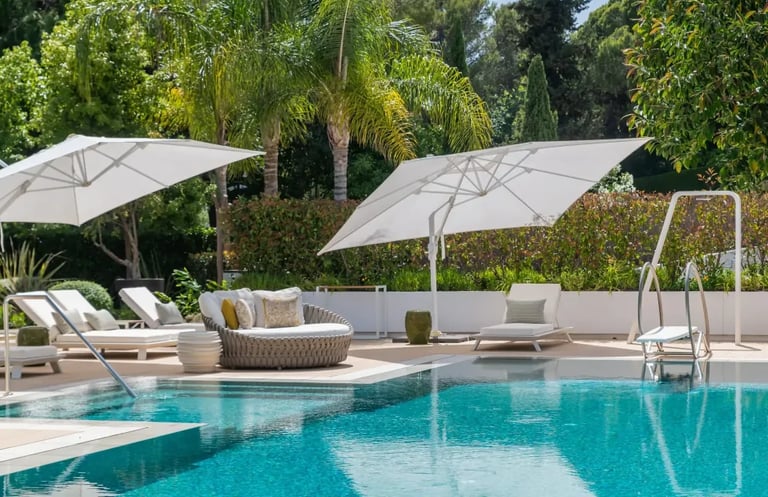 Poolside daybeds with umbrellas at Villa Serenity gardens
