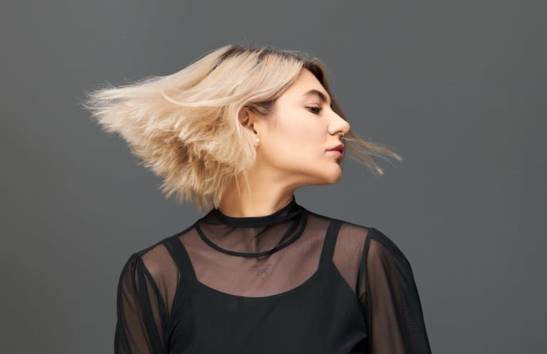 a woman with blonde hair and a black top