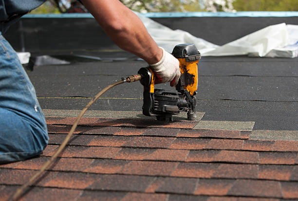 worker installing asphalt roof