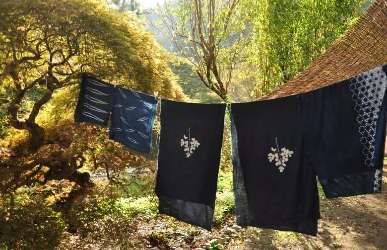 Traditional Japanese landscape view, blue indigo katazome fabrics hanging at the front