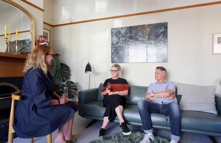 a couple talking to a woman