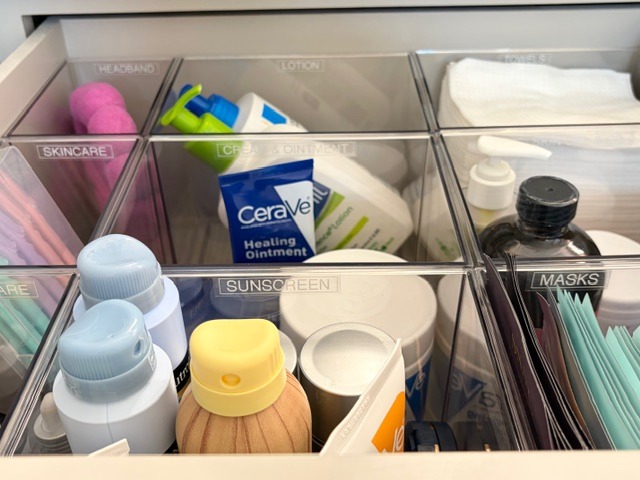 Bathroom drawer organization with acrylic inserts and labeled compartments for daily essentials