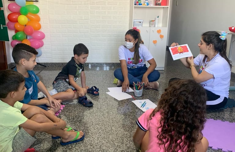 a group of children sitting on the floor in a circle