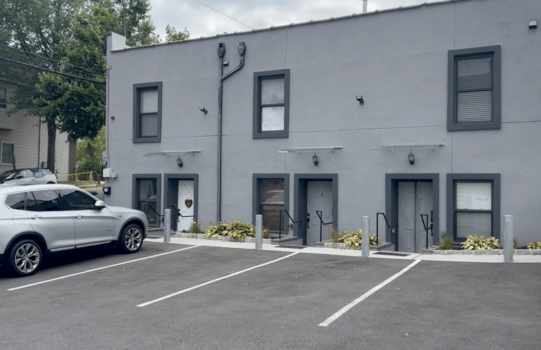 a car parked in a parking lot next to a building
