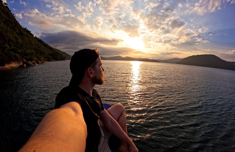 a man sitting on a boat in the ocean