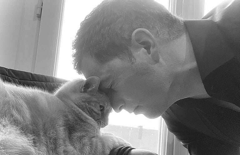 a man is holding a cat and a cat