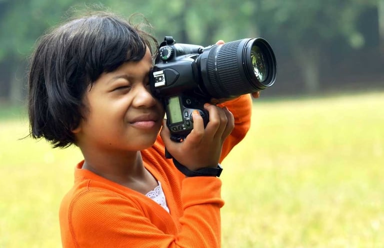 a young girl is taking a picture with a camera