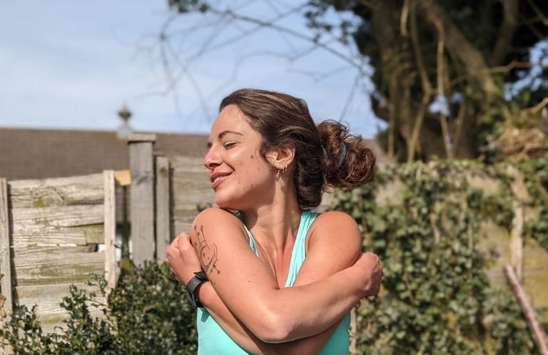 a woman in a blue tank top and a black watch on her wrist