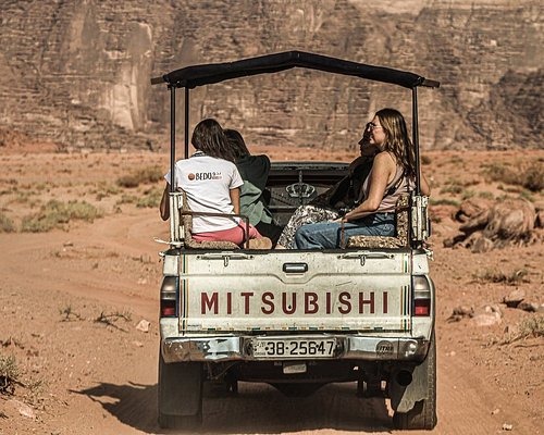 a couple of people riding in a truck
