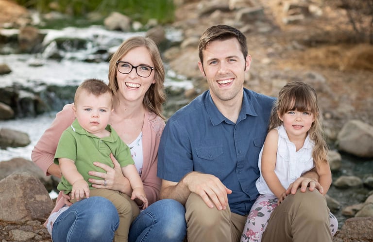 Family sitting together outdoors for a natural family portrait session in Gilbert, Arizona.