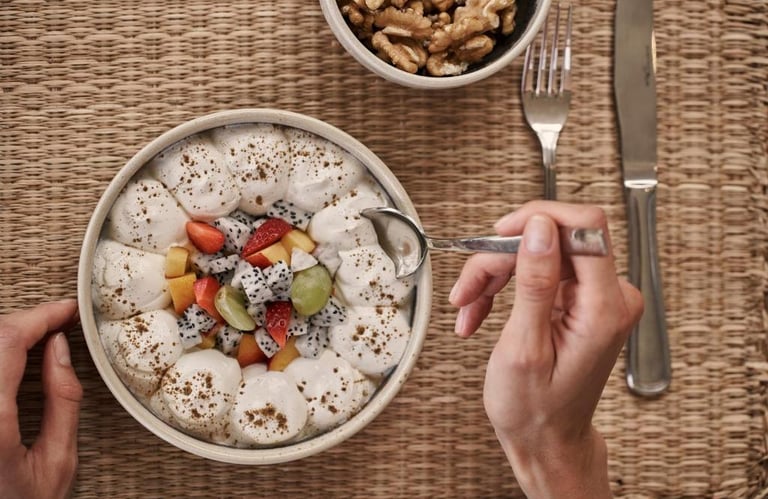 Elegant hotel room with a modern bed, private balcony, and stunning ocean views, perfect for a relaxing getaway.