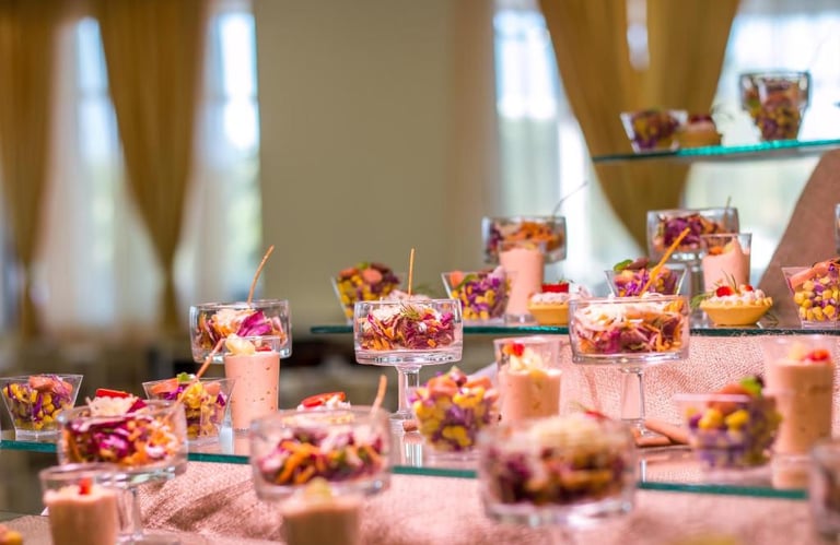 Gourmet appetizer buffet featuring small glasses of fresh vegetable salad and savory mousse.