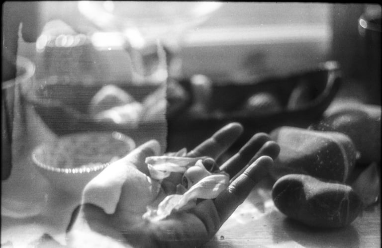 a hand holding delicate matter, being inspected and measured