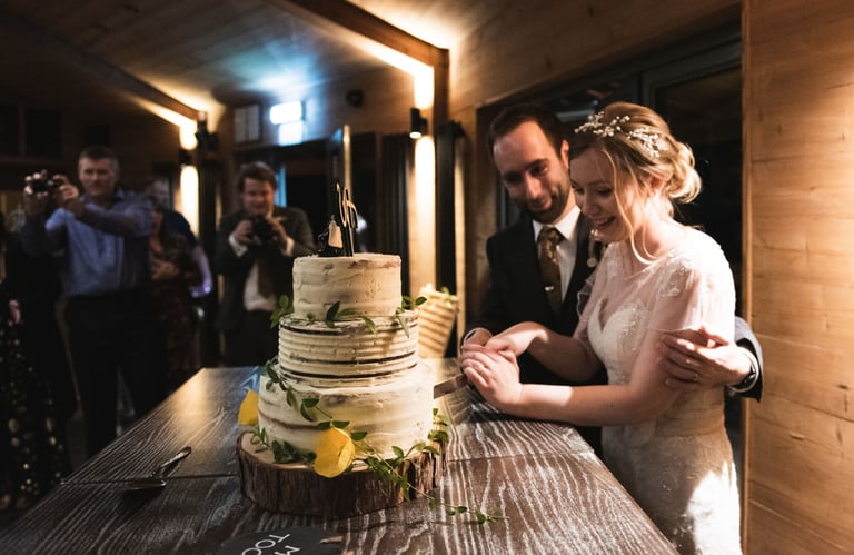 a bride and groom cutting their wedding cake
