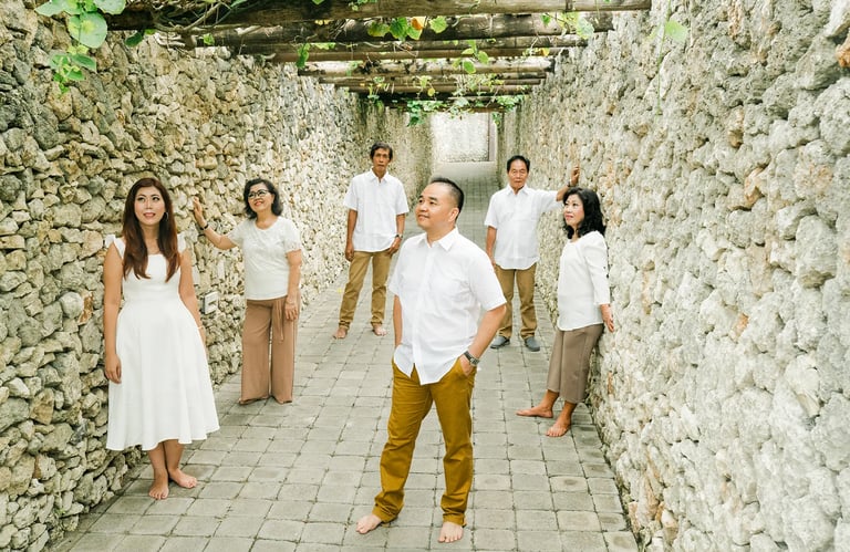 Selly family  through the stone pathway during a luxury family photography session at Karma Kandara Uluwatu Bali  