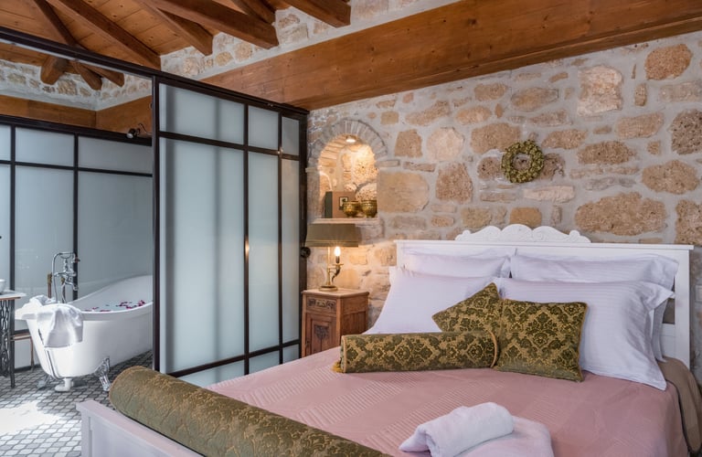 Convenient Queen size bed in open space bedroom with bathroom next to it in Villa Galanoussa Zakynthos