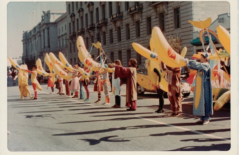 a group of people holding up yellow umbrellas