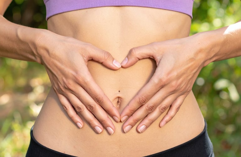 Woman's hands on stomach listening to gut feelings and body intuition