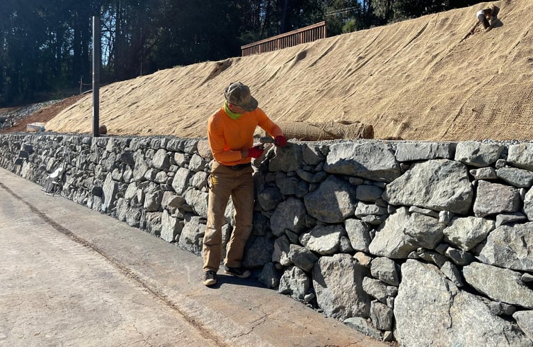 man working on rock wall in el paso, texas