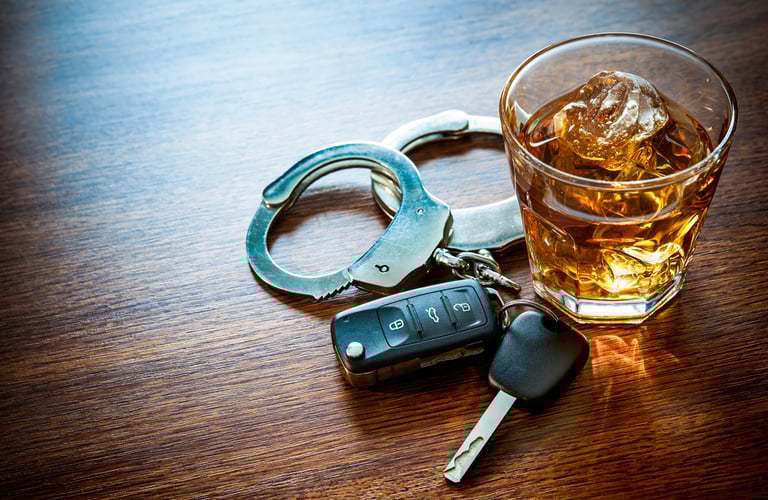 handcuffs, keys, and drink on table