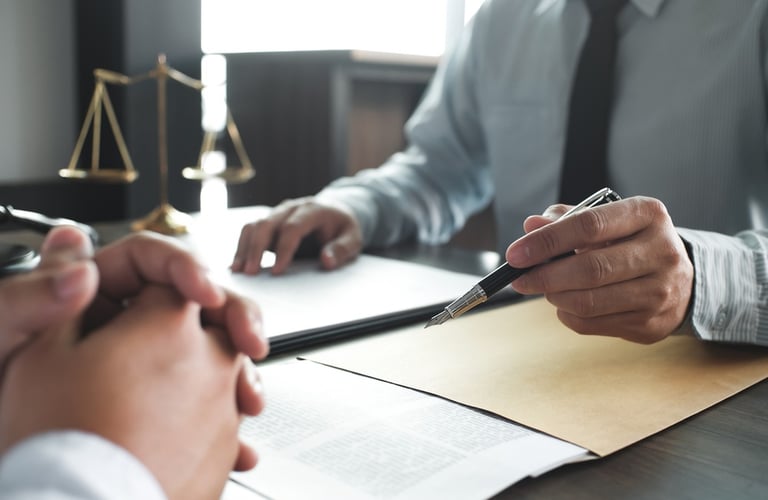 attorney meeting with client with paperwork