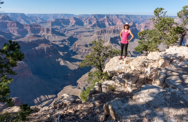 Janet standing on a cliff overlooking the Grand canyon