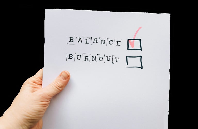 📝 Checkbox list with the words "Balance" and "Burnout" — hand ticking "Balance"