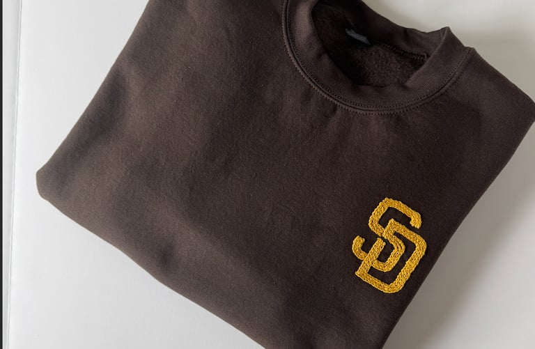a brown San Diego Padres sweatshirt with the SD logo embroidered in golden yellow