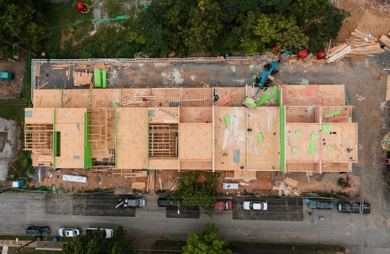 a building being built into a commercial complex with a roof that is being built into a