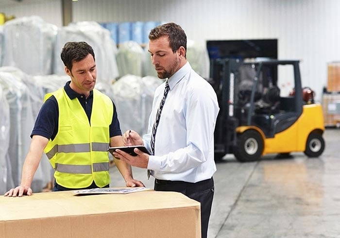 Warehouse workers reviewing survideo with integrated video surveillance and access control