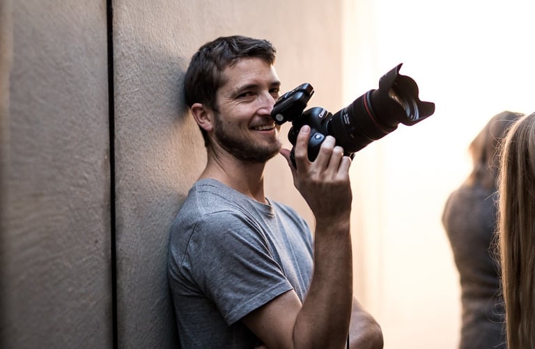 a man holding a camera and taking a picture