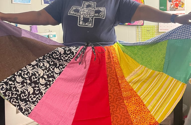 a black woman holding a rainbow - colored skirt