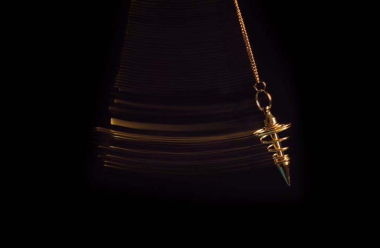 Gold pendulum used during a confidential paranormal assessment and spiritual consultation process