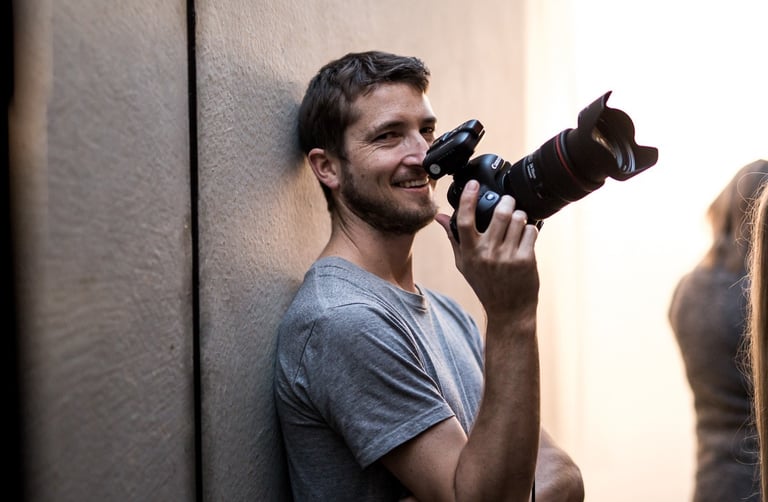 Product photography - a man holding a camera and taking a picture