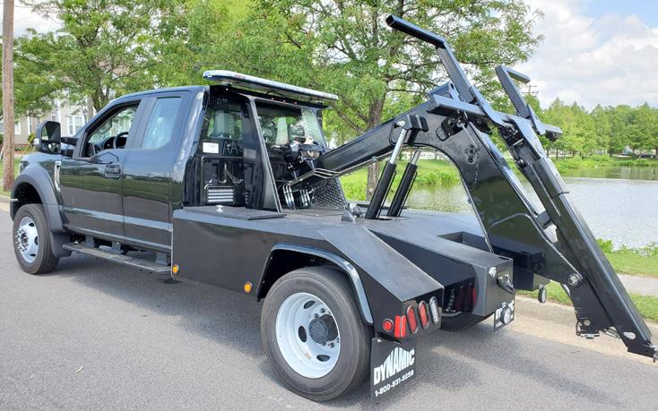 a black truck with a craned up to it's side