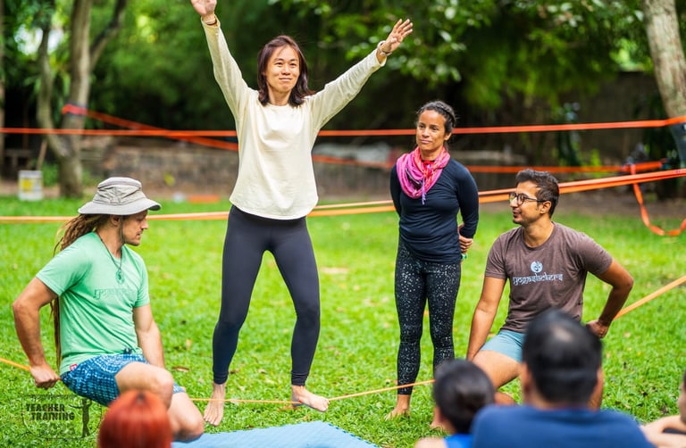 a woman learning to slackline with the YogaSlackers