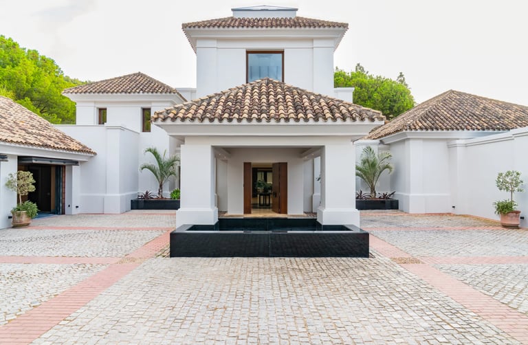 Main entrance courtyard with tiled roof and reflecting pool