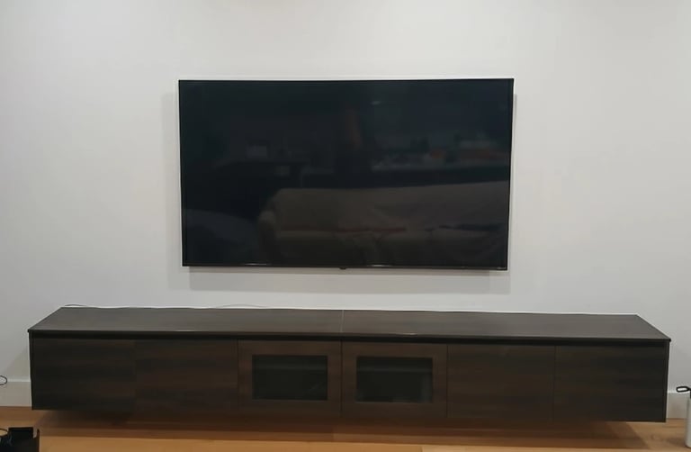 Space-saving ultra slim TV wall mounting for a compact apartment living room in Melbourne CBD.