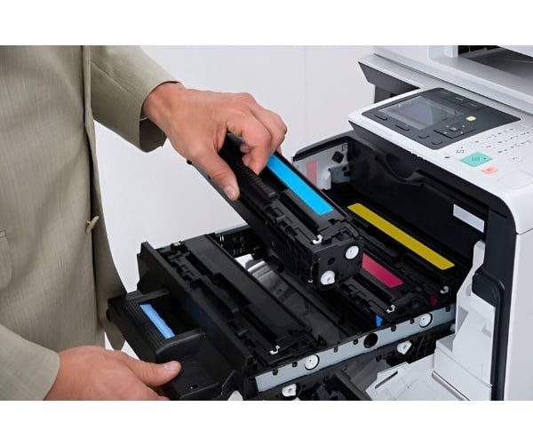 a man holding a printer and a printer