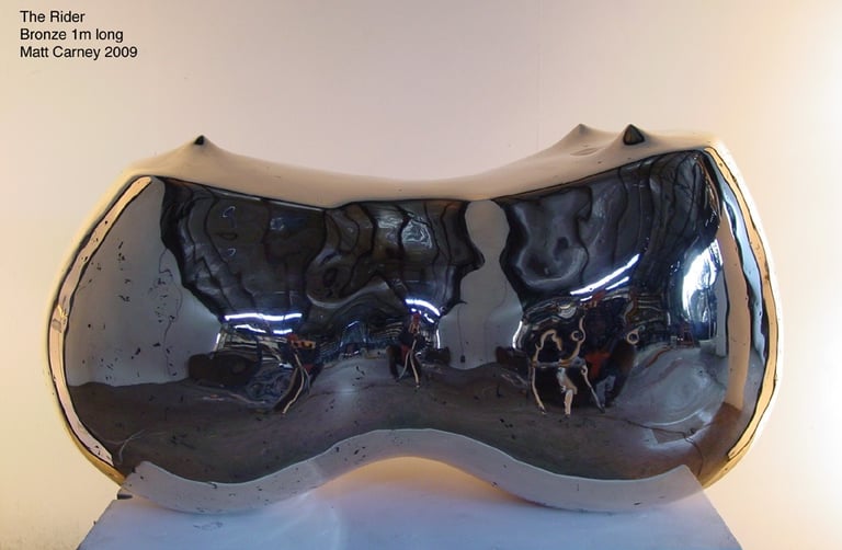 a polished bronze reflective sculpture of curved abstract form