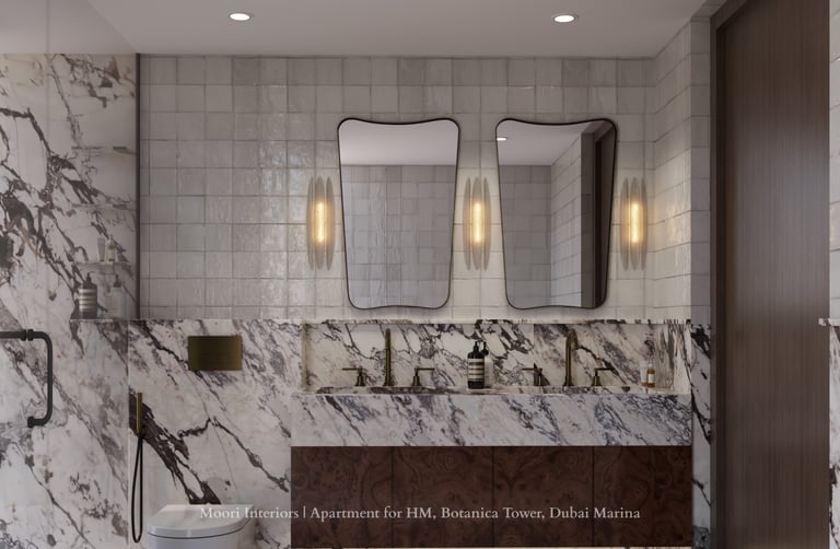 Marble-clad bathroom with two distinct mirrors and gold fixtures.