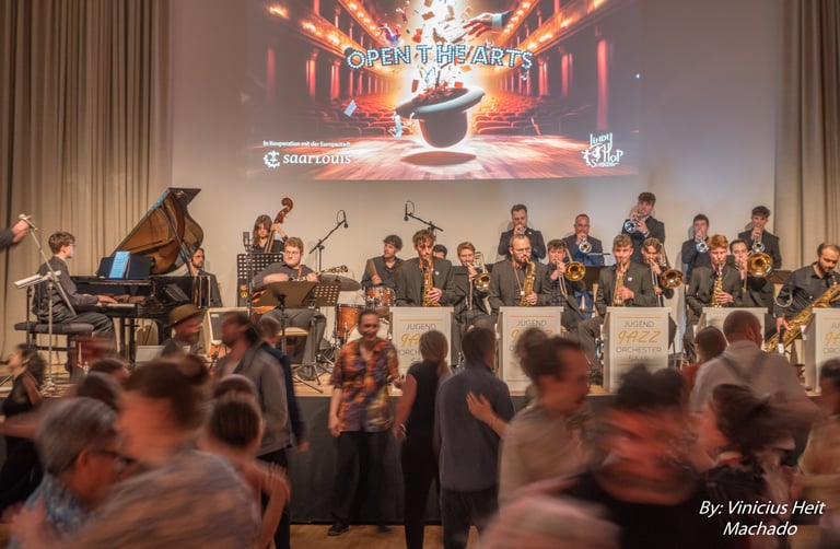 A live big band jazz orchestra performing on stage while people dance at a Lindy Hop swing event.