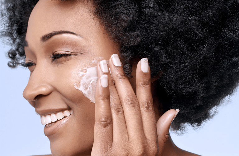 woman applying ori shea mousse to her face
