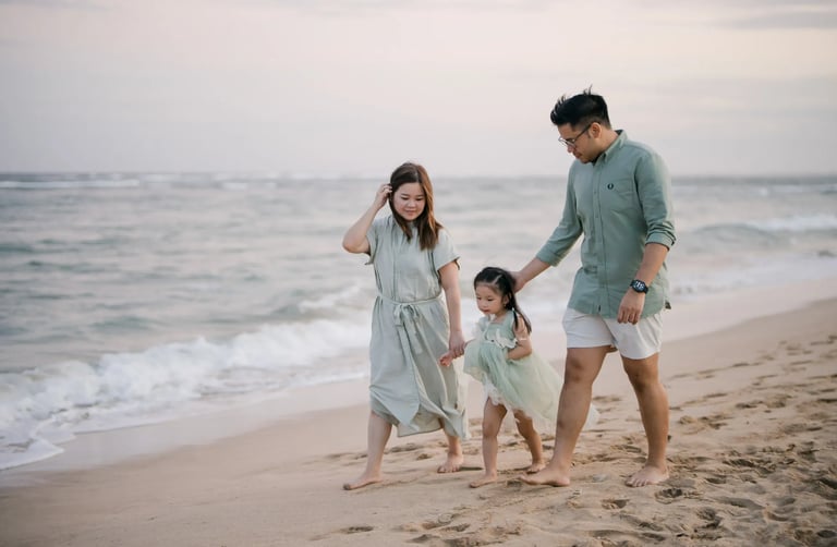 Parents and daughter walking together along the beach during a family photography session in Nusa Dua Bali.