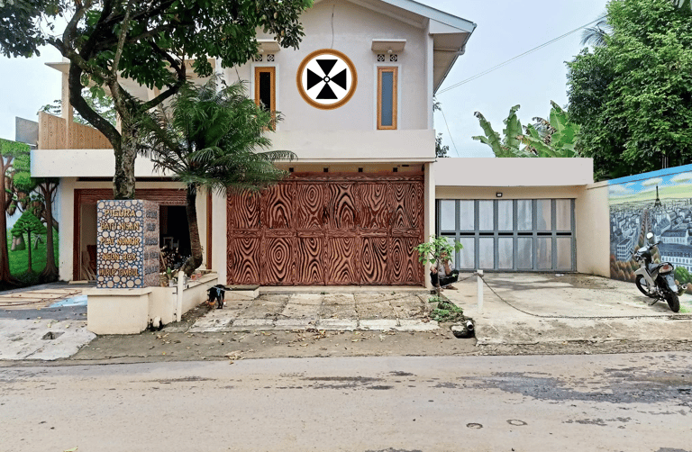 a house with a large wooden door and a large clock on the front of it