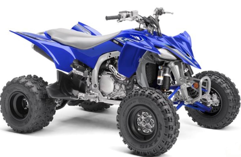 Blue Yamaha YFZ450R sport ATV with knobby tires and racing suspension on a white background.