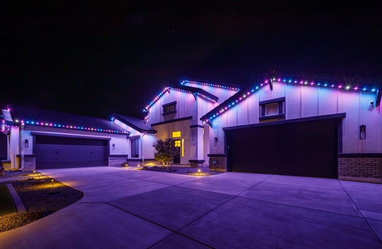 Bright holiday permanent lights on a house for a festive holiday display.