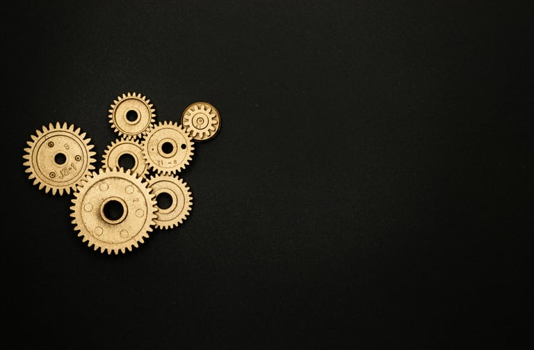wheels representing thinking and innovation, revealed behind a red theatre curtain