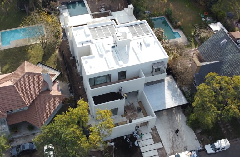 a house with a pool and a pool in the background